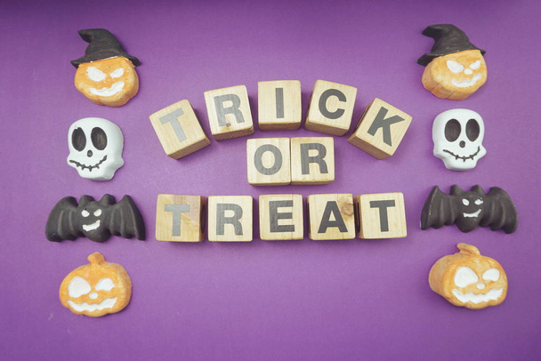 Trick or treat alphabet letters top view on purple background - Фото, изображение