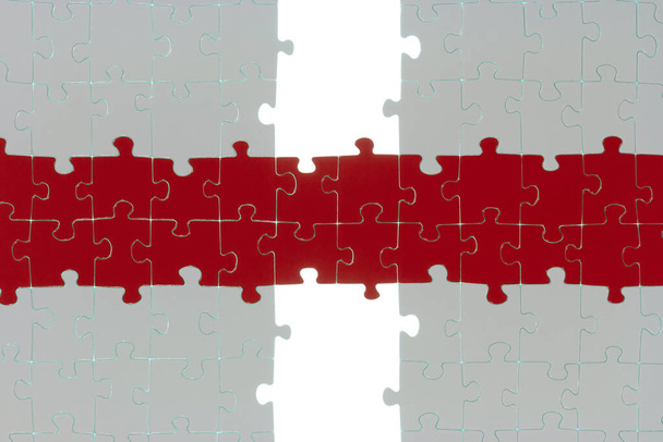 two white puzzle halves are linked by a colored way. - Zdjęcie, obraz