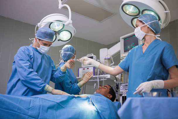 Team of surgeons during an operation in a hospital - Valokuva, kuva