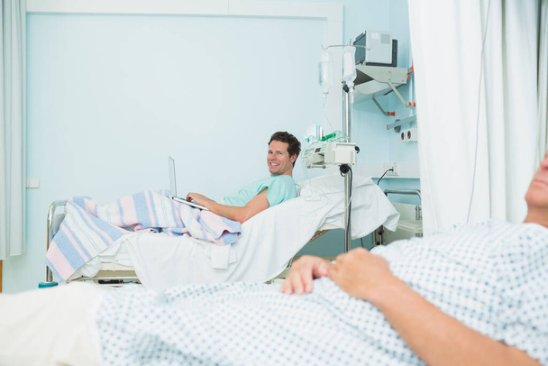 Male patients lying on hospital beds in a hospital ward - Foto, Imagem