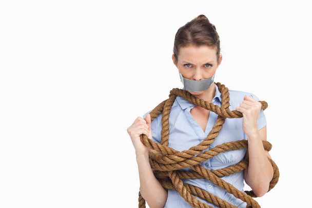 Businesswoman trying to untie herself - Zdjęcie, obraz