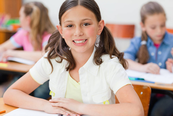 Smiling girl sitting in class - Photo, Image