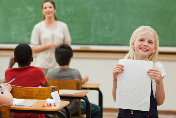 Smiling girl presenting her test results - Zdjęcie, obraz