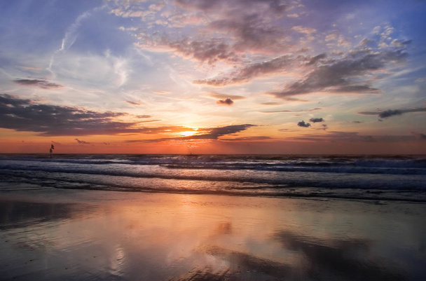 Colorful cloudy sunset at the beach with reflection - horizontal - Photo, Image