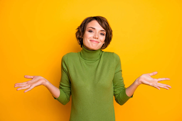 I dont know. Photo of beautiful lady spread hands shrug shoulders careless ignorance expression said bad wrong thing wear casual green turtleneck isolated yellow color background - Photo, Image