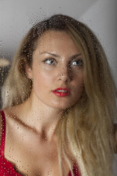 woman seen in lingerie by a window - Fotografie, Obrázek