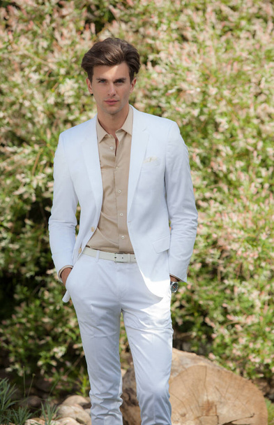 Young elegant handsome man posing outside. - Фото, изображение