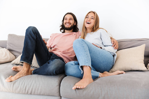 Couple on sofa watch tv film indoors at home. - Valokuva, kuva