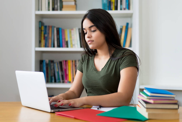 Spanish female student working at computer - Фото, изображение