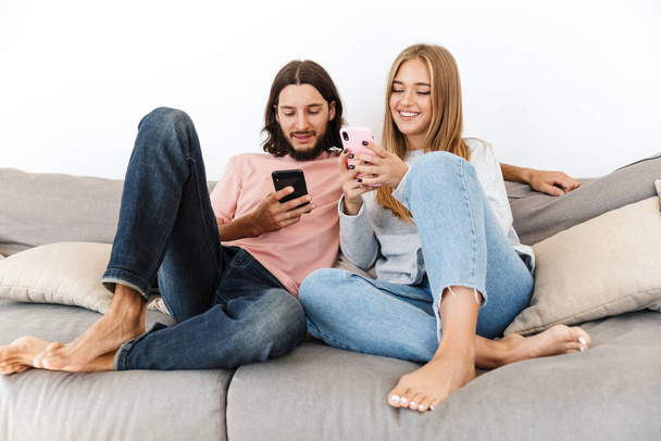 Happy lovely couple relaxing on a couch at home - Foto, imagen