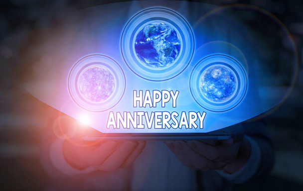 Conceptual hand writing showing Happy Anniversary. Business photo showcasing The annually recurring date of a past event celebration Elements of this image furnished by NASA. - 写真・画像