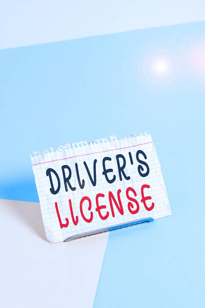 Text sign showing Driver S License. Business photo text a document permitting a demonstrating to drive a motor vehicle Paper placed tilted above buffer wire on soft pastel multi colours backdrop - Photo, Image