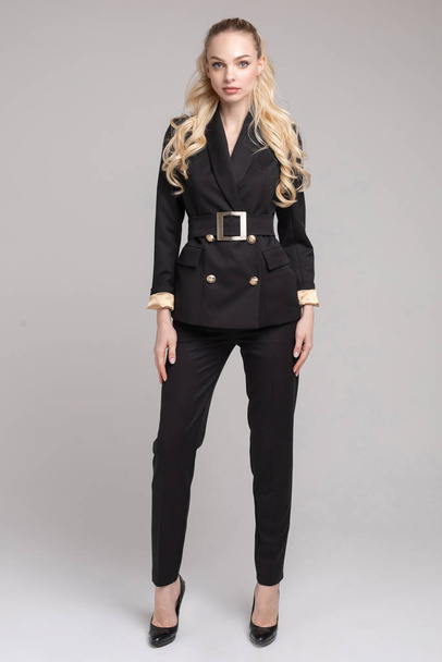 Attractive elegant woman in black office suit and heels. - Foto, imagen