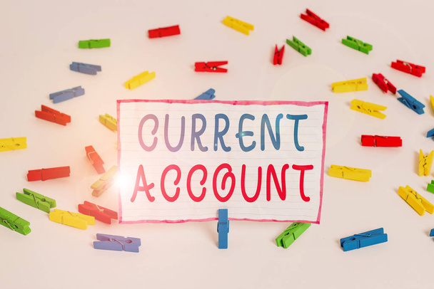 Conceptual hand writing showing Current Account. Concept meaning demonstrating bank account which can take out money any time Colored clothespin papers empty reminder white floor office - Photo, Image