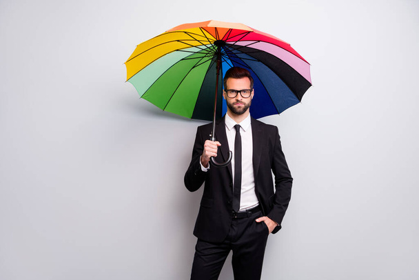 Portrait of confident bearded cool entrepreneur go walk work have rainy day hold colorful umbrella wear blazer jacket white black necktie good look isolated over grey color background - Фото, изображение