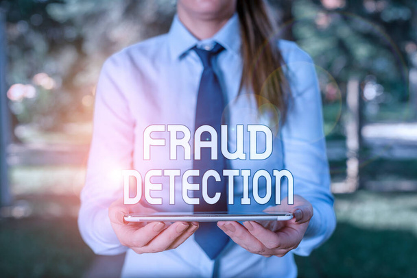 Text sign showing Fraud Detection. Conceptual photo identification of actual or expected fraud to take place Business woman in shirt with a tie holding lap top mobile phone in the hand. - Fotoğraf, Görsel