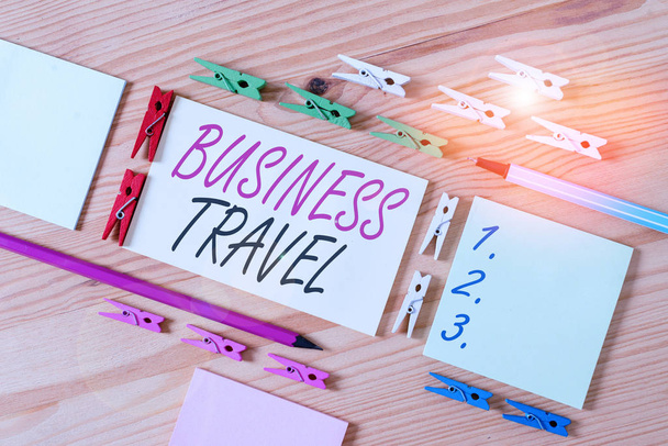 Word writing text Business Travel. Business photo showcasing travel on behalf of a company to one or more destinations Colored clothespin papers empty reminder wooden floor background office - Фото, изображение