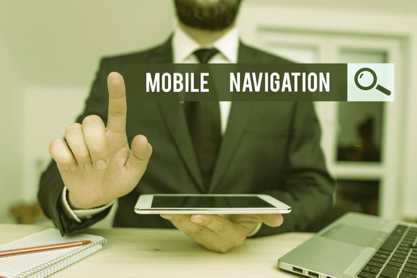 Conceptual hand writing showing Mobile Navigation. Business photo showcasing graphical user interface used to aid the vehicle driver Male human wear formal clothes present use hitech smartphone. - Photo, Image