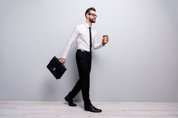 Full size profile side photo real estate agent broker go walk apponitment with partners hold espresso cup hold handbag wear white shirt black pants trousers isolated grey color background - Foto, imagen