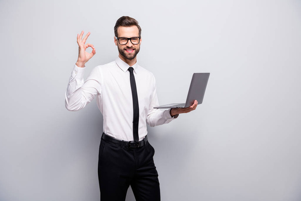 Joyful confident cool man real estate agent smm work his laptop approve excellent start-up seminar project show ok sign wear white shirt black pants trousers isolated grey color background - Φωτογραφία, εικόνα