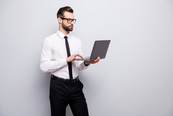Portrait of confident cool expert man entrepreneur use computer read document make project look screen wear white black outfit isolated over grey color background - Φωτογραφία, εικόνα