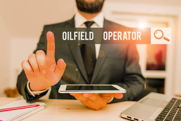 Conceptual hand writing showing Oilfield Operator. Concept meaning responsible for optimizing production of the oil wells Male human wear formal clothes present use hitech smartphone - Photo, Image