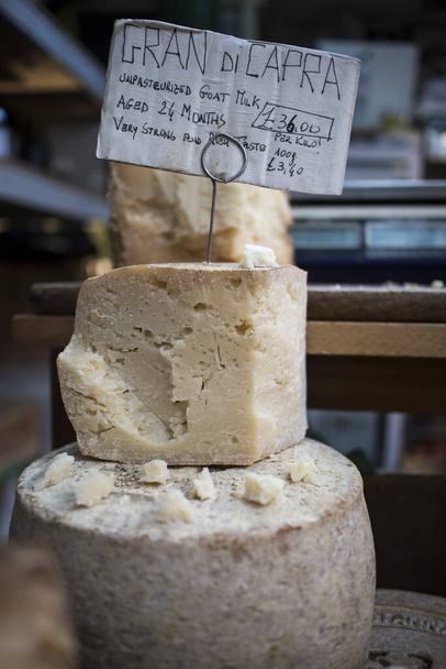 Various types of cheese on counter for sale at Borough Market - Photo, image