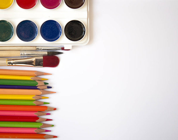 Watercolor paints and brushes, top view. Creative artistic mocku - Fotó, kép