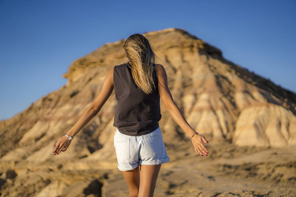 portrait of young beautiful woman walking in the desert of the Bardenas Reales, Navarra, Spain - Fotografie, Obrázek