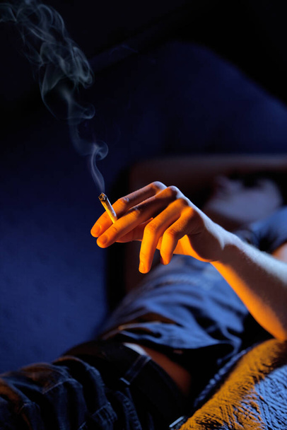 Close up of teenage boy smoking drugs, copy space - Foto, Imagem