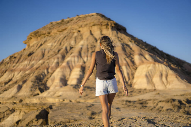 portrait of young beautiful woman walking in the desert of the Bardenas Reales, Navarra, Spain - Foto, afbeelding