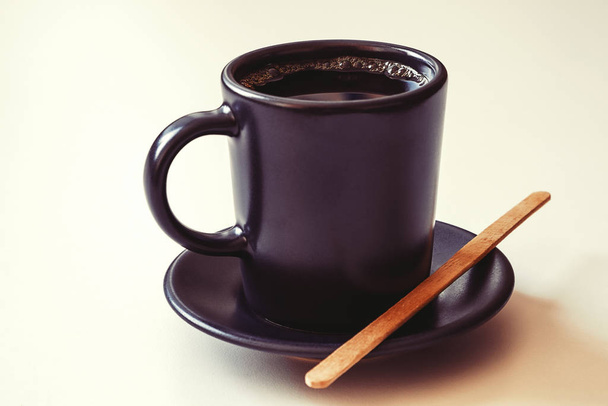 A Cup of espresso. Wooden bamboo stirring stick. Morning invigorating drink. - Photo, Image