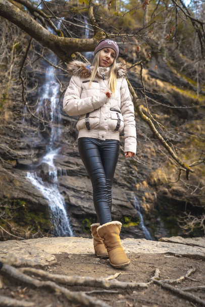 portrait of young woman near waterfall - Fotoğraf, Görsel