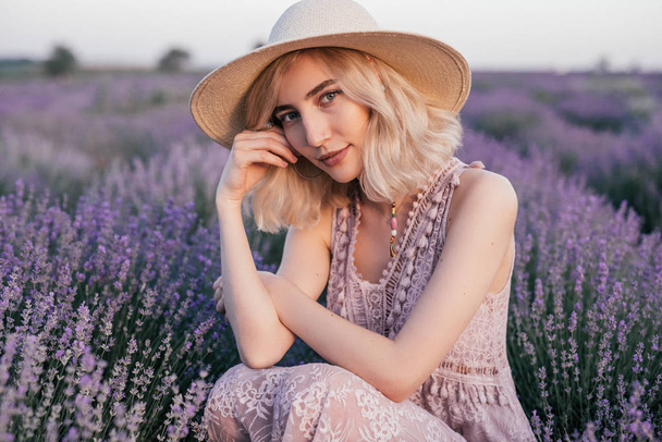 Stylish young female resting in lavender meadow - Фото, изображение