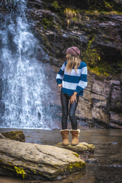 portrait of young woman near waterfall - Fotoğraf, Görsel