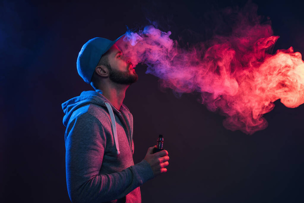 Vaping e-liquid from an electronic cigarette - Photo, Image