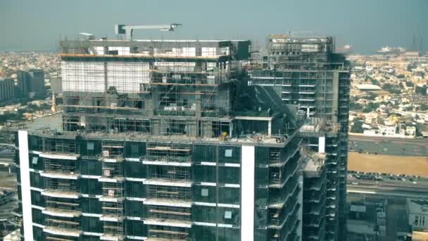 Aerial view of a skyscraper construction site details. Dubai, UAE - Filmati, video