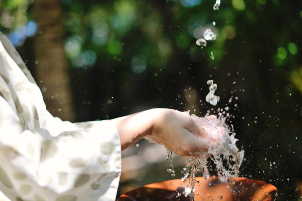 splashing fresh  water drops on girl soft skin  care for sensuality woman hands - Fotó, kép
