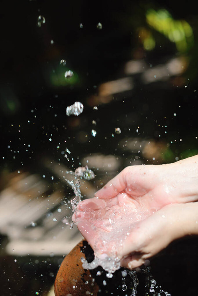 splashing fresh  water drops on girl soft skin  care for sensuality woman hands - Foto, Imagen
