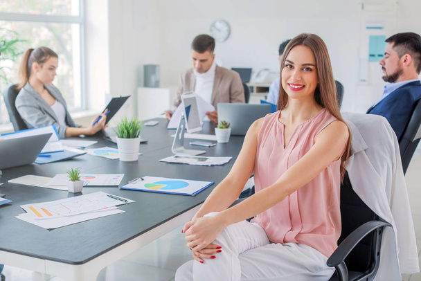 Young businesswoman during meeting in office - Foto, afbeelding