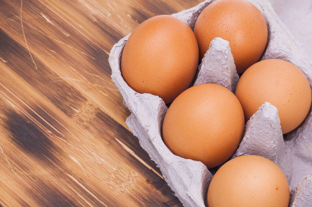 raw eggs on wooden plate - Φωτογραφία, εικόνα