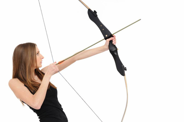 Beautiful woman aiming with bow and arrow - 写真・画像