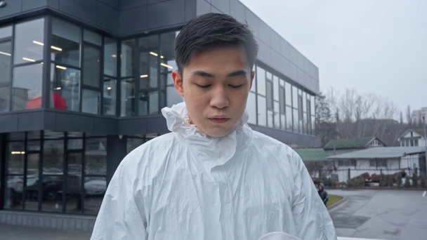 asian scientist taking off medical mask outside - Footage, Video