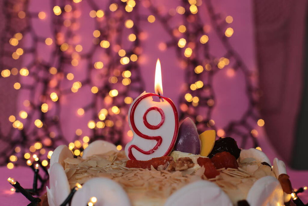 Burning candle in the cake - Photo, Image