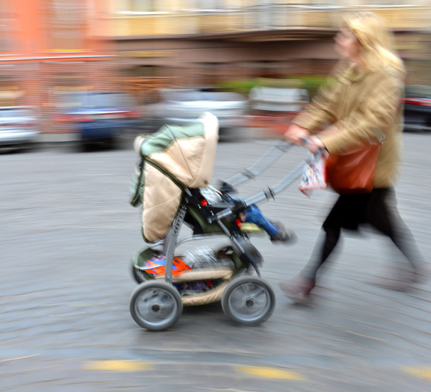 Bebek arabası çocuk ile anne yürür - Fotoğraf, Görsel