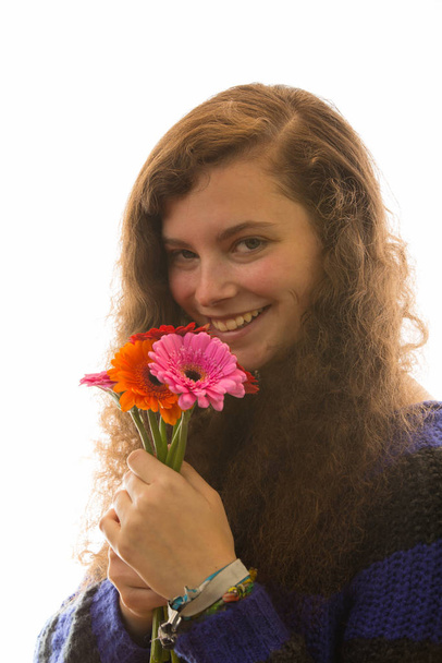 a young pretty woman is holding a flower bouquet in the hand - Φωτογραφία, εικόνα