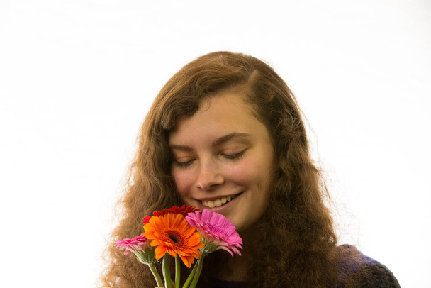 a young pretty woman holding a flower bouquet in hand - 写真・画像