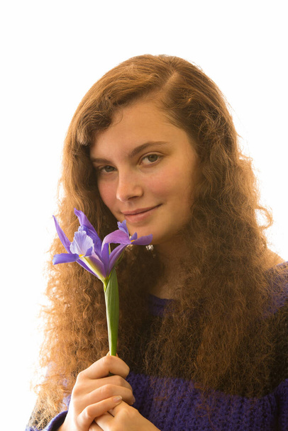 a young pretty woman is holding a flower in the hand - Photo, image