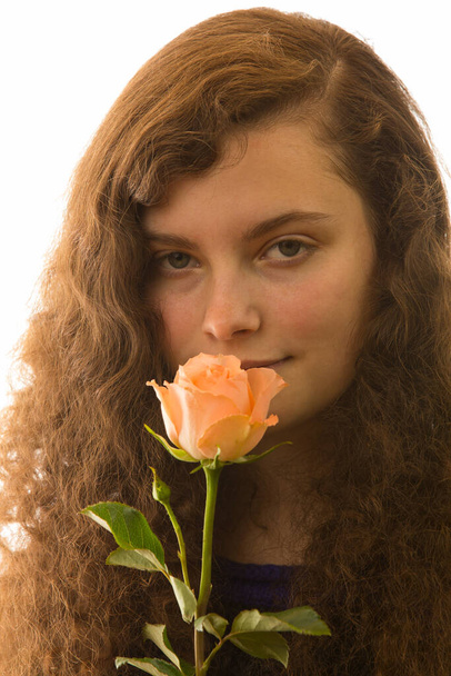 a young pretty woman is holding a rose in her hand - Photo, image
