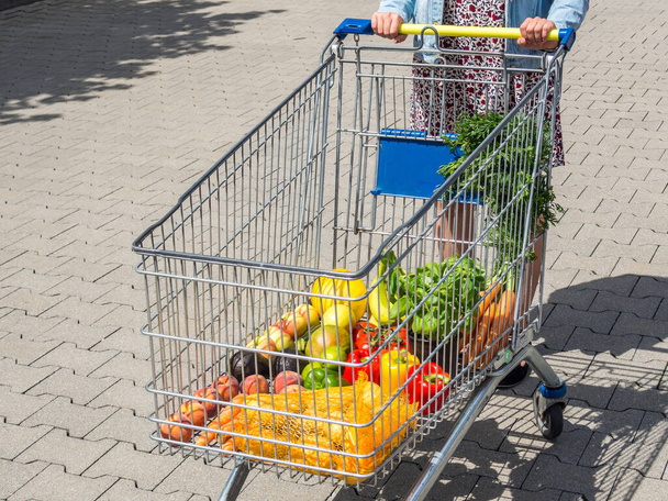 live healthy: woman buys fruits and vegetables - Photo, Image